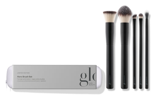 A collection of five high-performance, vegan makeup brushes displayed alongside their packaging which reads 'hero brush set'. The brushes are designed for various makeup applications including powder, concealer, foundation, eyeshadow, and eyeliner.